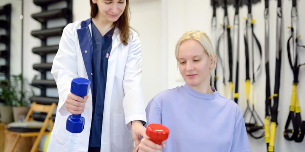 Patient working with physical therapist after suffering a TBI in a car accident